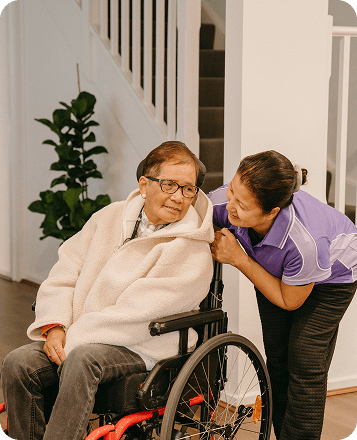 A Bopha Cares disability worker assisting Romana around the home